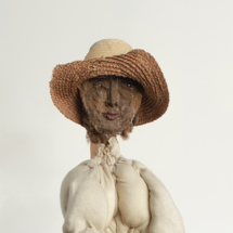 Shaman, Hogmawg, fabric, wood, buttons, straw hat, stool 57 x 15 x 21 inches